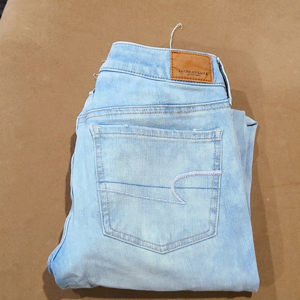 Ladies Super Super stretch x4 American Eagle light blue with worn out knees.